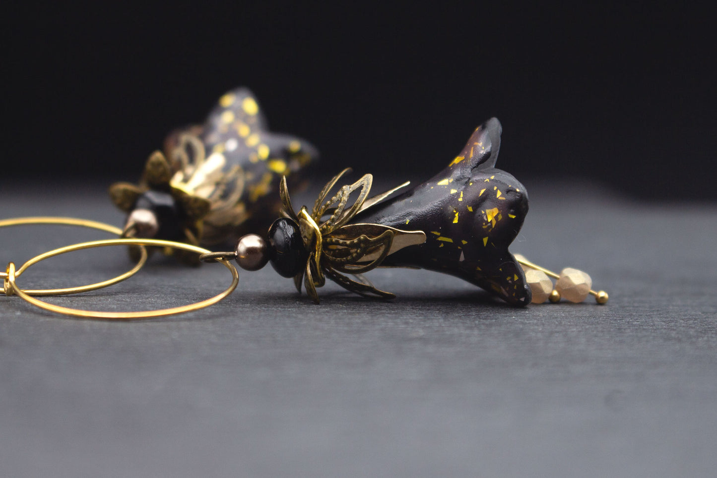 Schwarze Blütenohrringe mit Gold Creolen – modernes Schmuckdesign