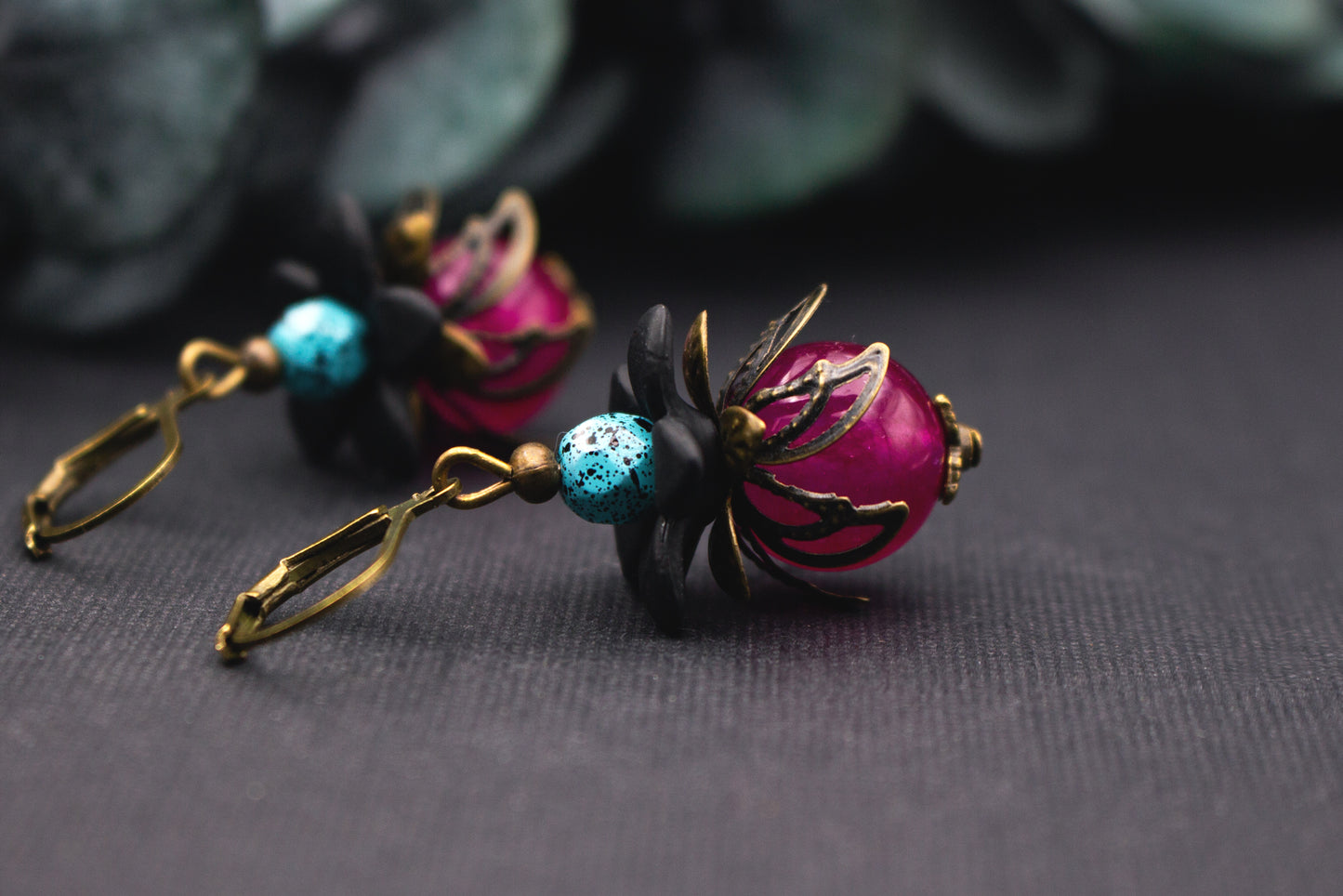 Glasperlenohrringe Pink Türkis mit schwarzen Blüten und Bronze – stimmungsvoller floraler Ohrschmuck im farbkräftigen Design.