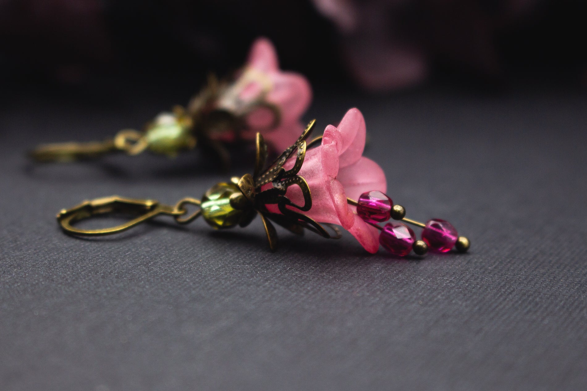 Roséfarbene Blumenohrringe mit pinken Glasperlen und grüner Akzentperle im Vintage-Stil – zarter Schmuck für besondere Anlässe.
