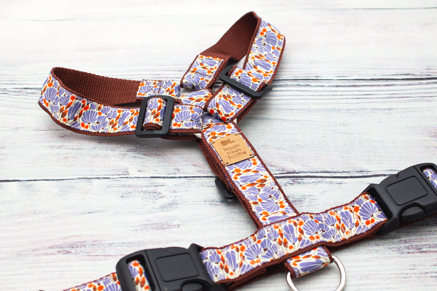 Detailaufnahme des Hundegeschirrs DANDELIGHT mit grafischen Pusteblumenformen in Lila und kleinen Punkten in Orange, hochwertiges Gurtband im warmen Naturton.