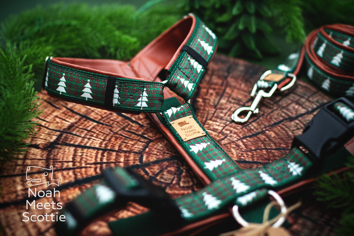 Handgefertigtes Hundegeschirr MERRY LITTLE PINE TREES und passende Hundeleine im gleichen dunkelgrün-roten Weihnachtsmuster mit weißen Tannenbäumen.