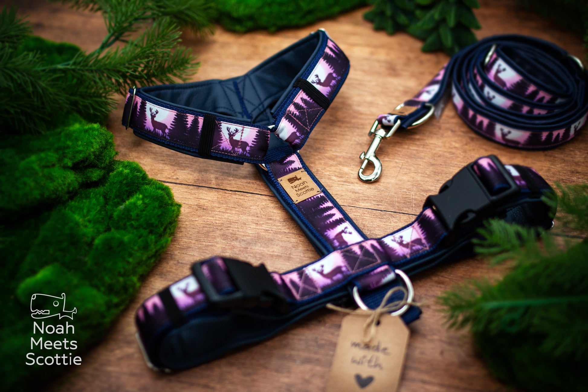 Detailaufnahme des Hirschmotivs vor einer dunklen Waldlandschaft mit Tannen in Dunkelblau, Violett und Rosa.