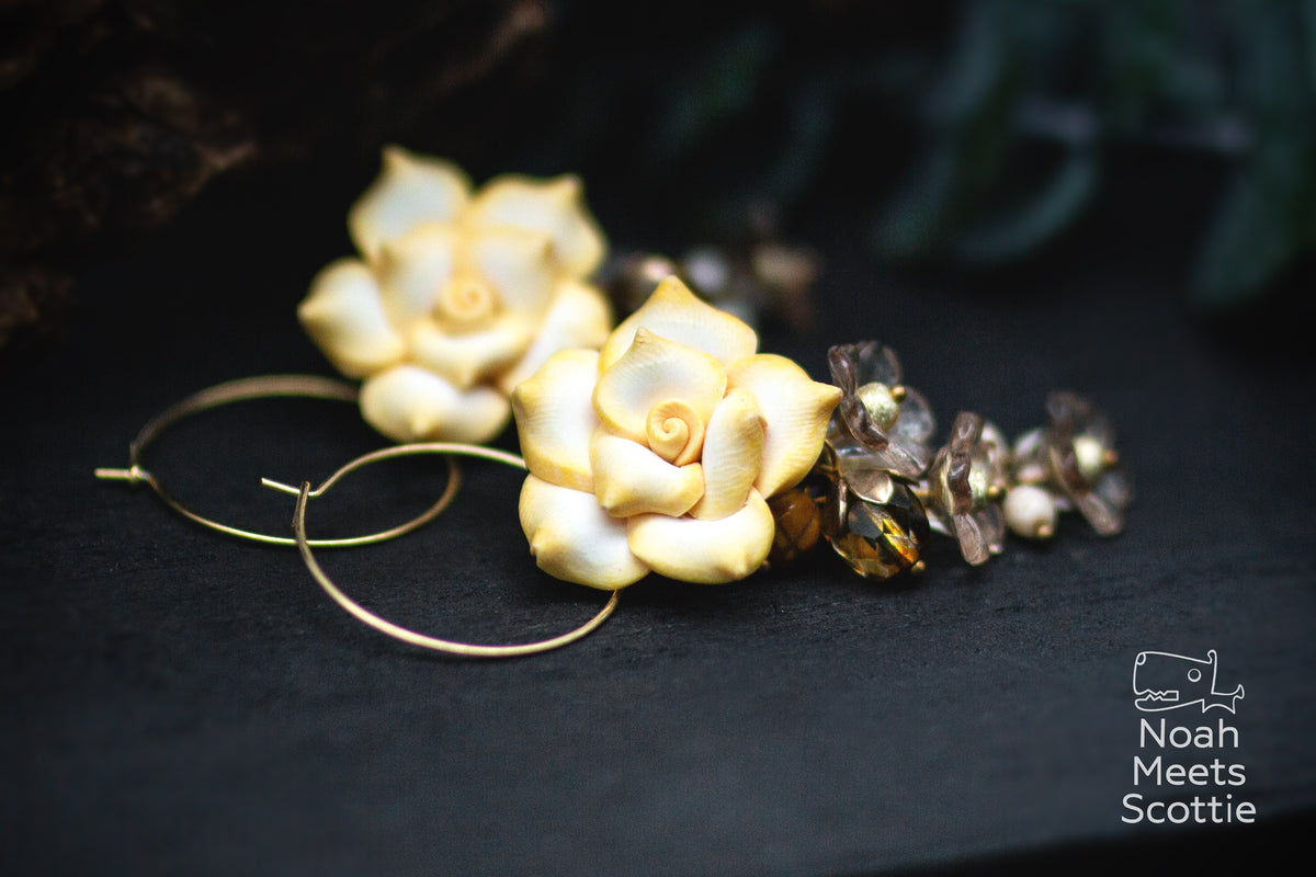 Goldfarbene Rosen Creolen in Vanillegelb mit warmen Bernsteinperlen und kleinen taupe-grauen Blüten.