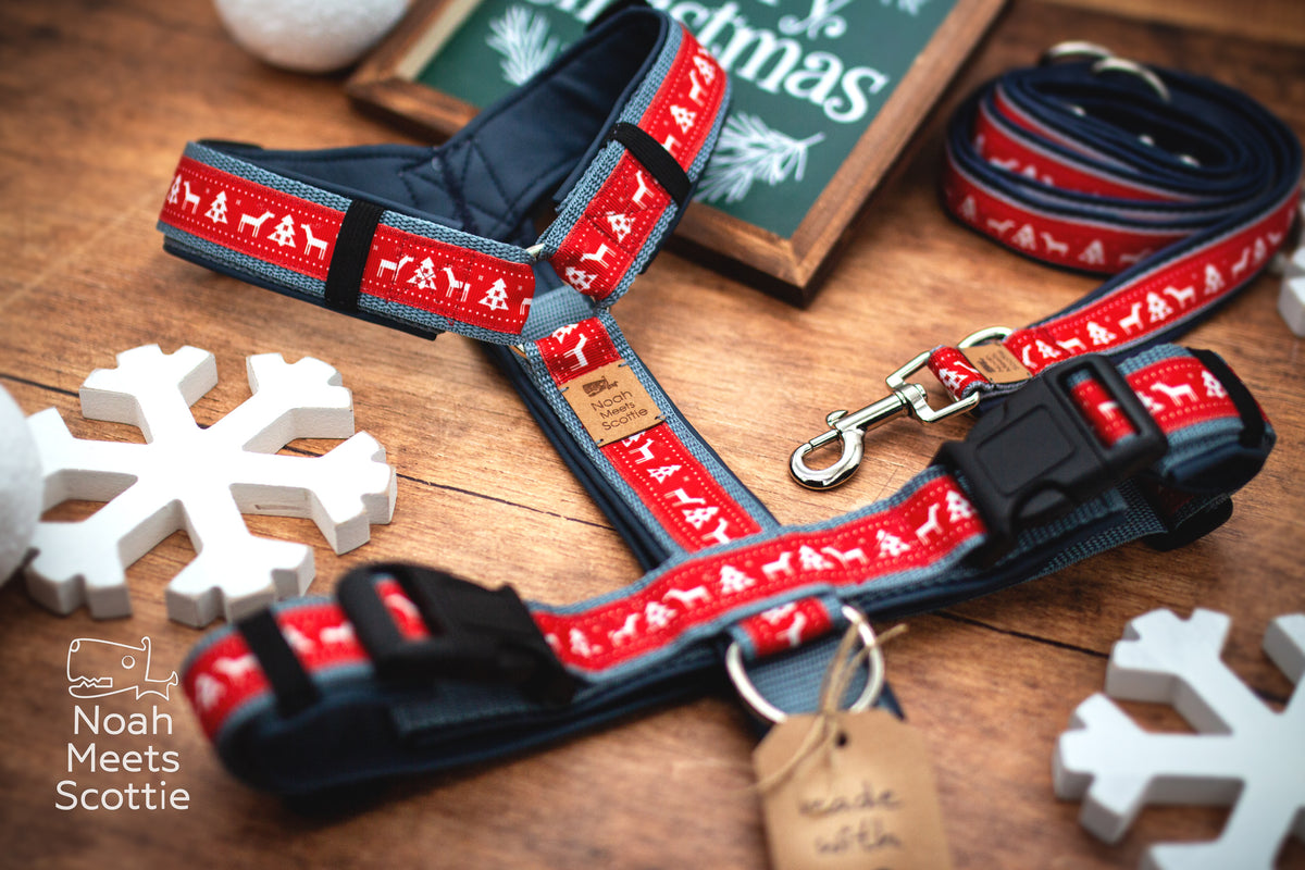 Seitenansicht des verstellbaren Hundegeschirrs KNITMAS EVE mit weißen Rentieren und Tannen auf rotem Grund.